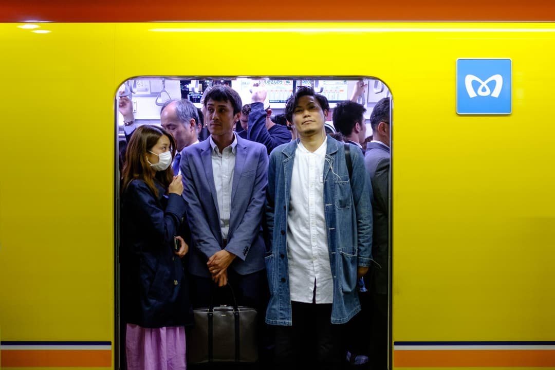 Landscape photograph of a Japan Railways train door, with passengers looking out from the inside