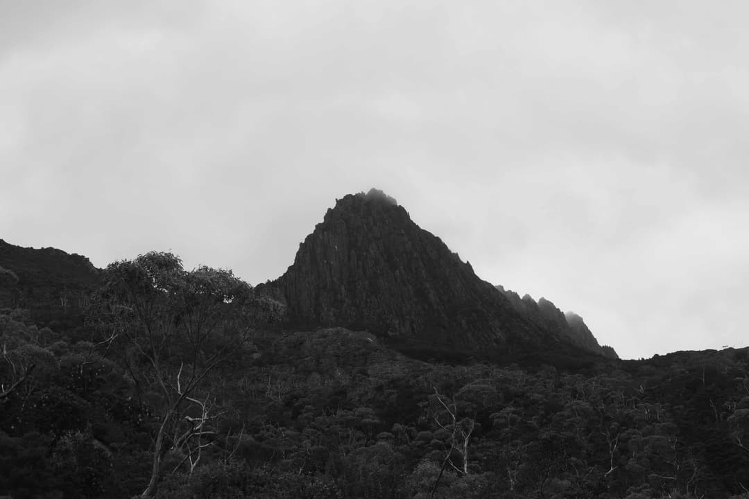 Black and white photograph of a close by mountain peak