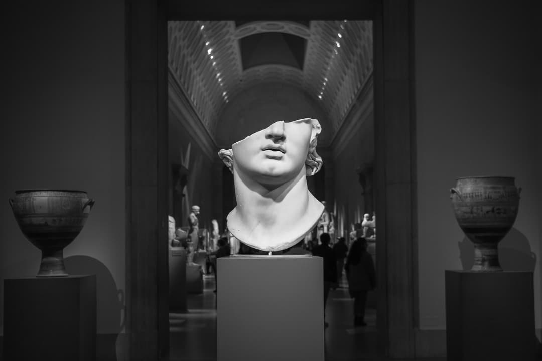 Grayscale photo of woman sculpture