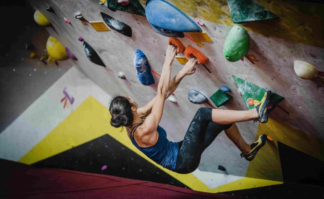 Woman bouldering in an indoor gym